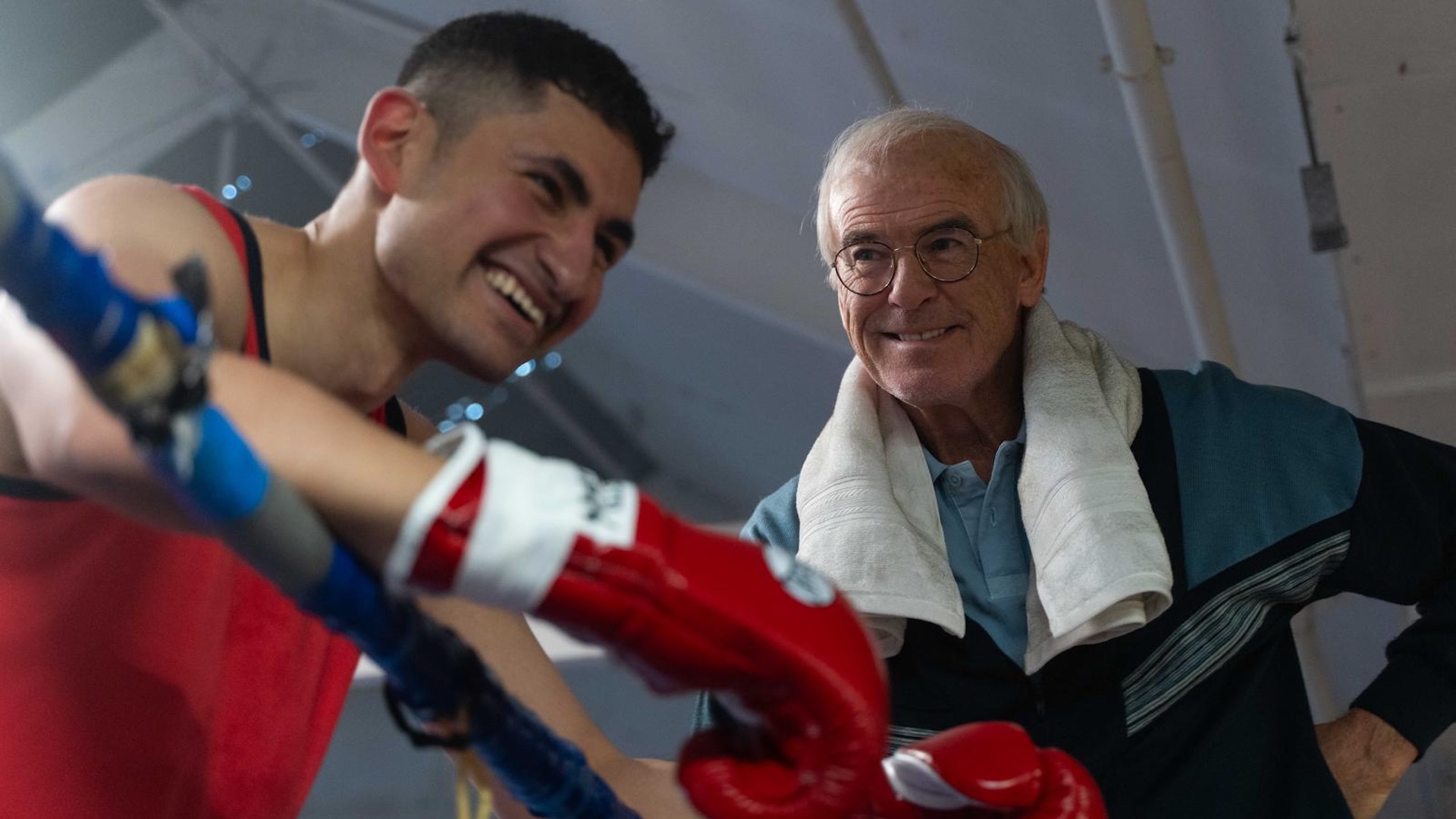 an image of amir el-masry as Naz and Pierce Brosnan and Brendan Ingle mid-training in the film Giant