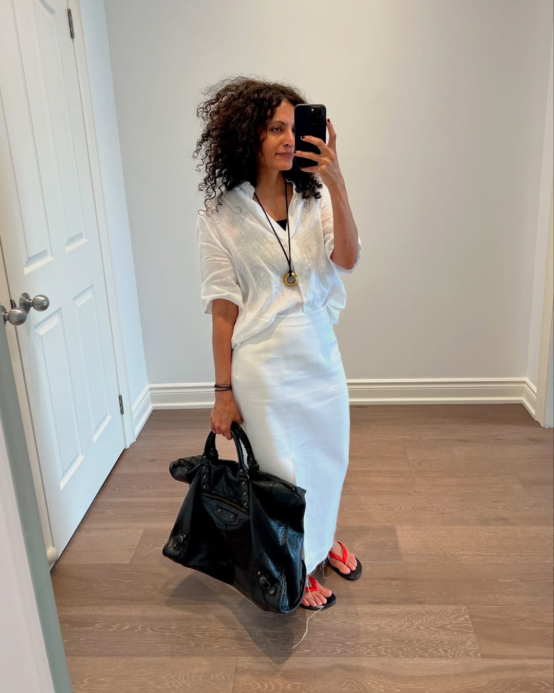 Influencer wearing a linen shirt with a white skirt