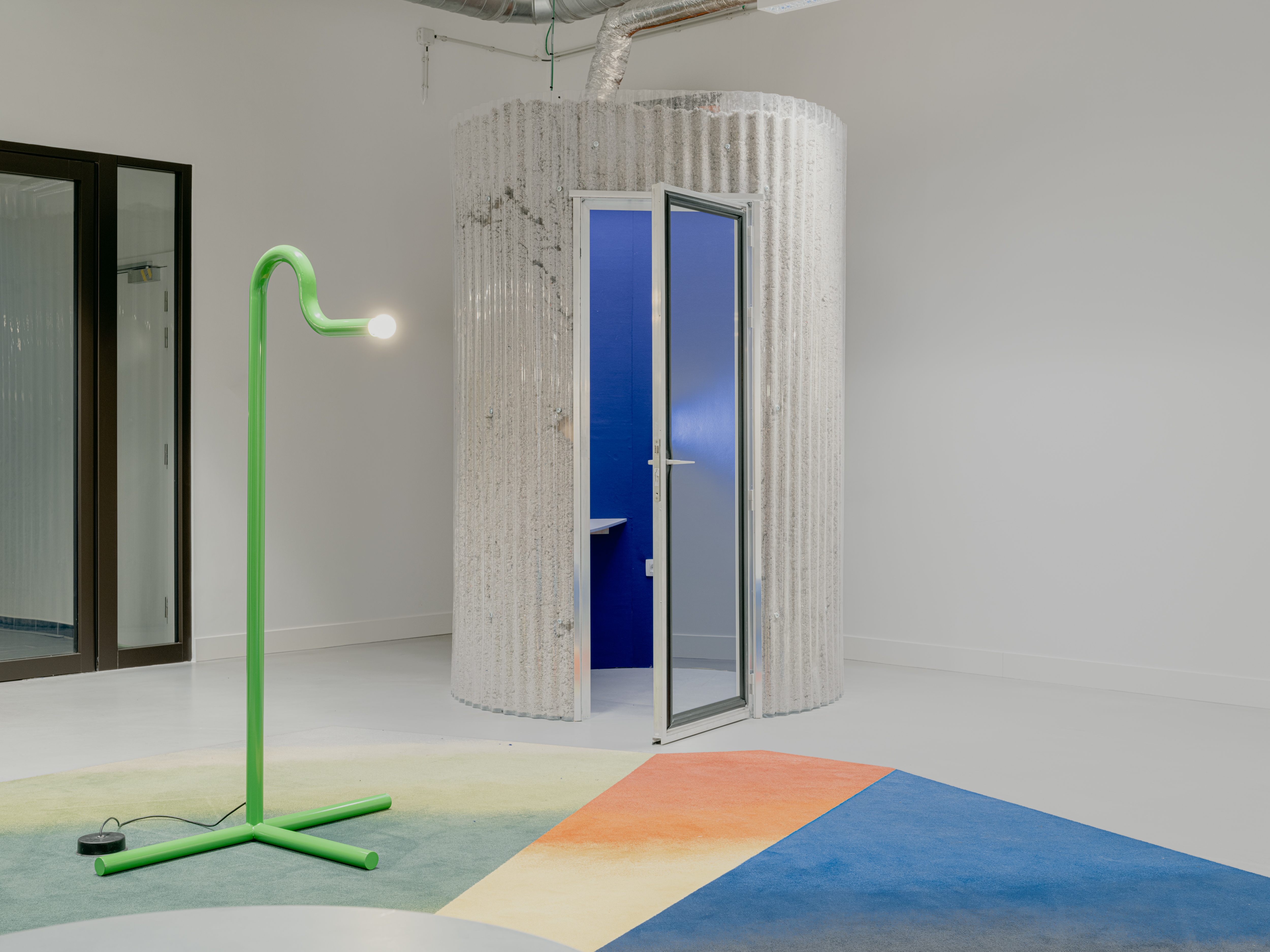 Green lamp and geometric rug