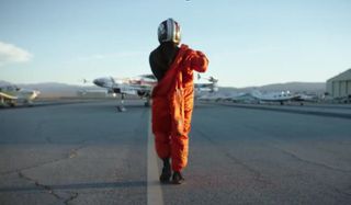 Star Wars: Rogue Squadron Patty Jenkins walks towards an X-Wing, putting on a flight suit