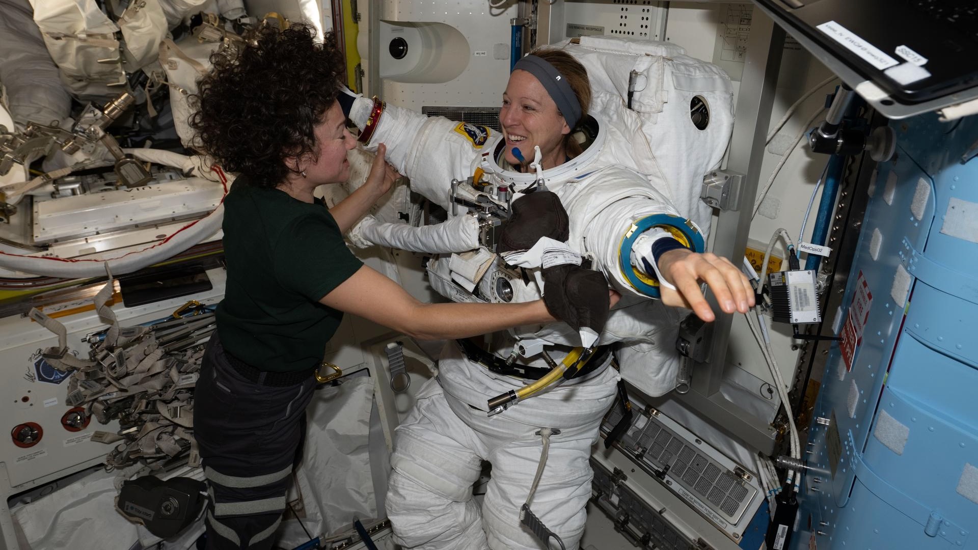 NASA astronaut Jessica Meir and the European Space Agency's Sophie Adenot work together inside the International Space Station&rsquo;s Quest airlock during spacesuit fit and leak checks.