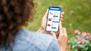 A customer shopping on walmart dot com using her cell phone