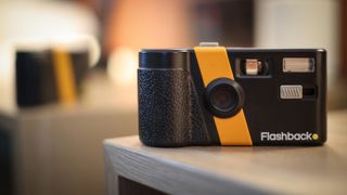 Lifestyle photo of the Flashback camera on a warm wooden surface