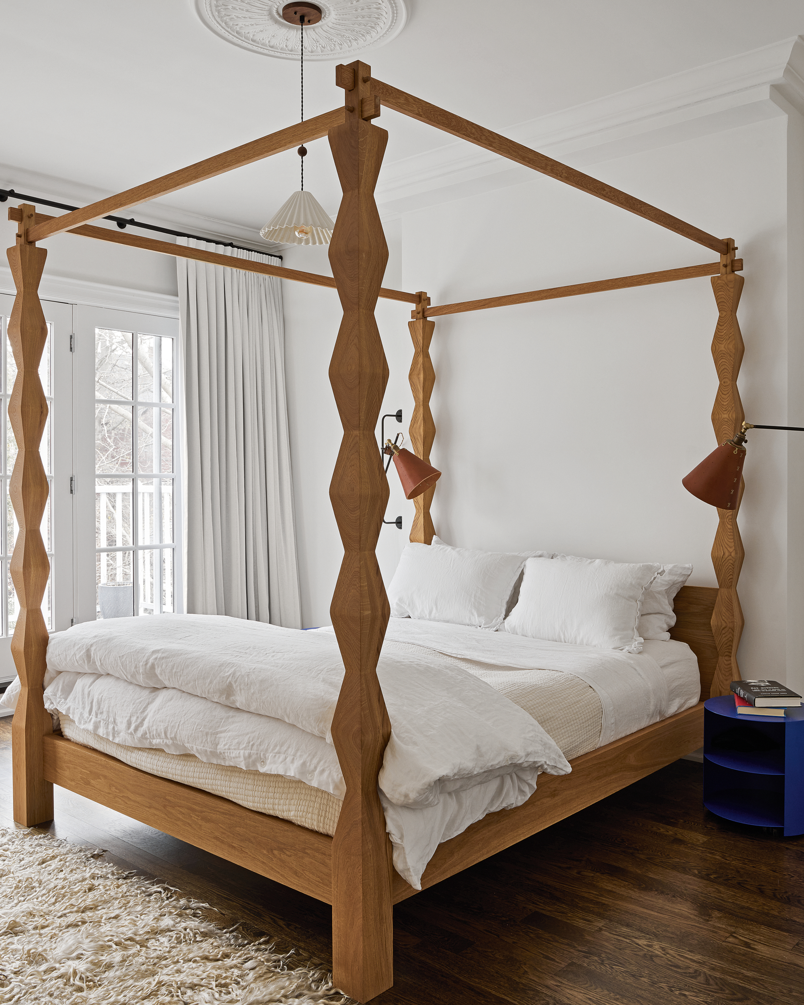 White bedroom with contemporary timber four-poster bed