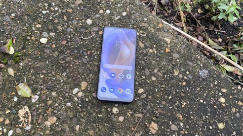 A Moto G31 with the screen on, outside