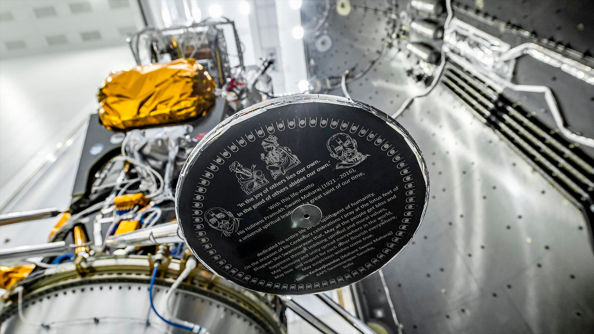 a close-up of one of the footpads on a lunar lander shows a tribute to a Hindu spirtual leader printed on the pad's underside