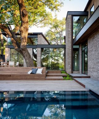 Wooden bench, tiled pool, glass walls