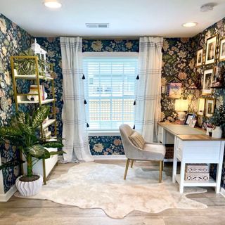 Small office with rug and floral wallpaper on dark blue