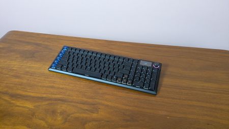 Three-quarter view of Corsair Vanguard Air 99 Wireless+ open on a brown desk 