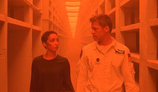 Ad Astra Ruth Negga and Brad Pitt walk through an orange lit hallway