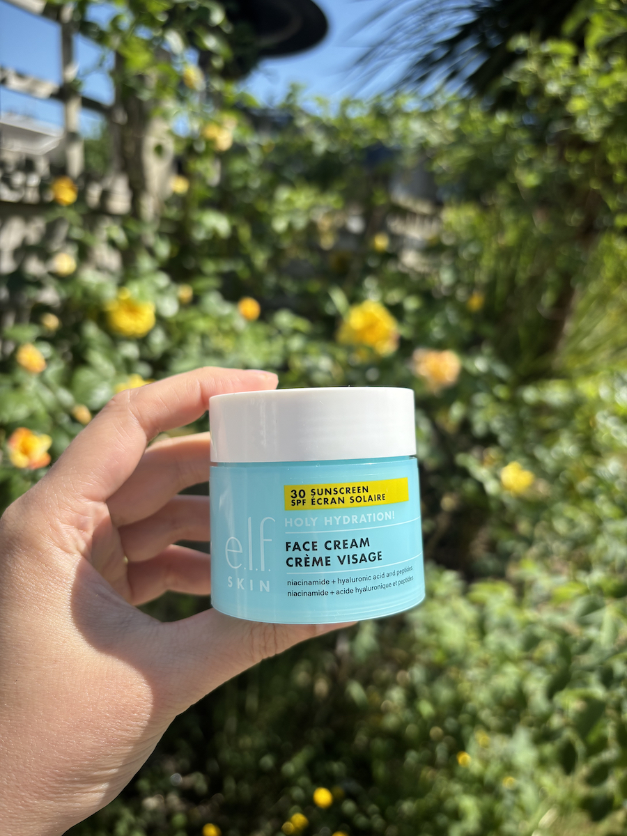 Mica Ricketts holding E.L.F. Skin Holy Hydration! Face Cream SPF 30