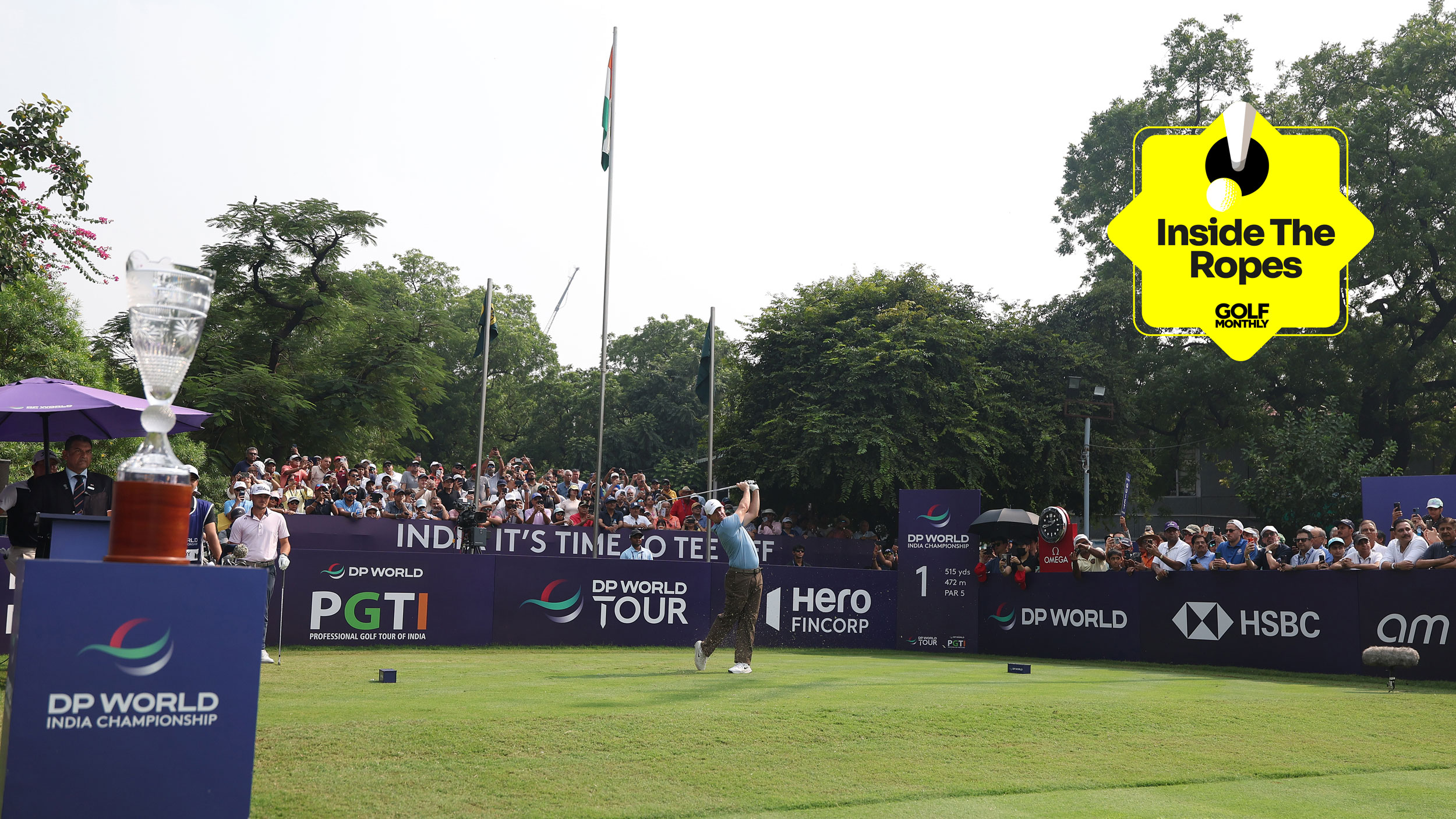 Rory McIlroy tees off at the DP World India Championship and a yellow Inside The Ropes sticker in the top-right