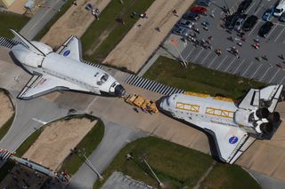 NASA's space shuttles Endeavour and Atlantis switched locations August 16, 2012, at Kennedy Space Center in Florida, and in the process came "nose-to-nose" for the last time in front of Orbiter Processing Facility 3.