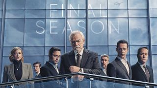 Succession season 4 key art featuring (L to R) Sarah Snook as Shiv, Nicholas Braun as Greg, Kieran Culkin as Roman, Brian Cox as Logan, Alan Ruck as Connor, Jeremy Strong as Kendall and Matthew Macfayden as Tom, standing on the balcony of a skyscraper