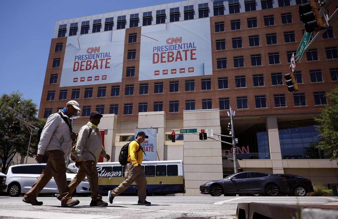 Pedestrians walk past CNN signage ahead of June 27 debate