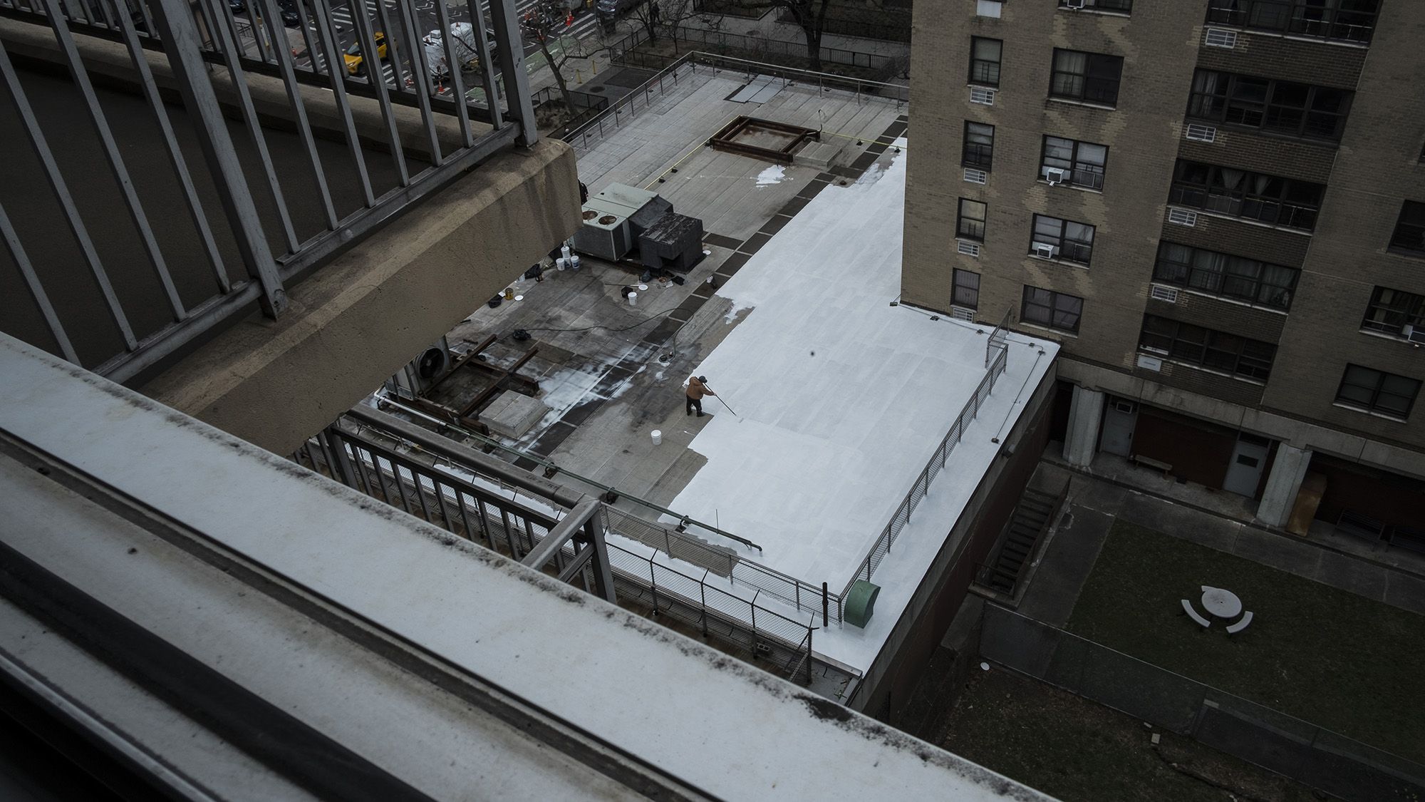 A view of a white roof in the middle of a city