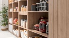 A wooden pantry shelf unit with glass jars of food