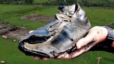 Someone holding a roman shoes discovered at Magna Fort, a Roman fort located near Hadrian's Wall.