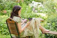 Woman Using A Tablet In The Garden