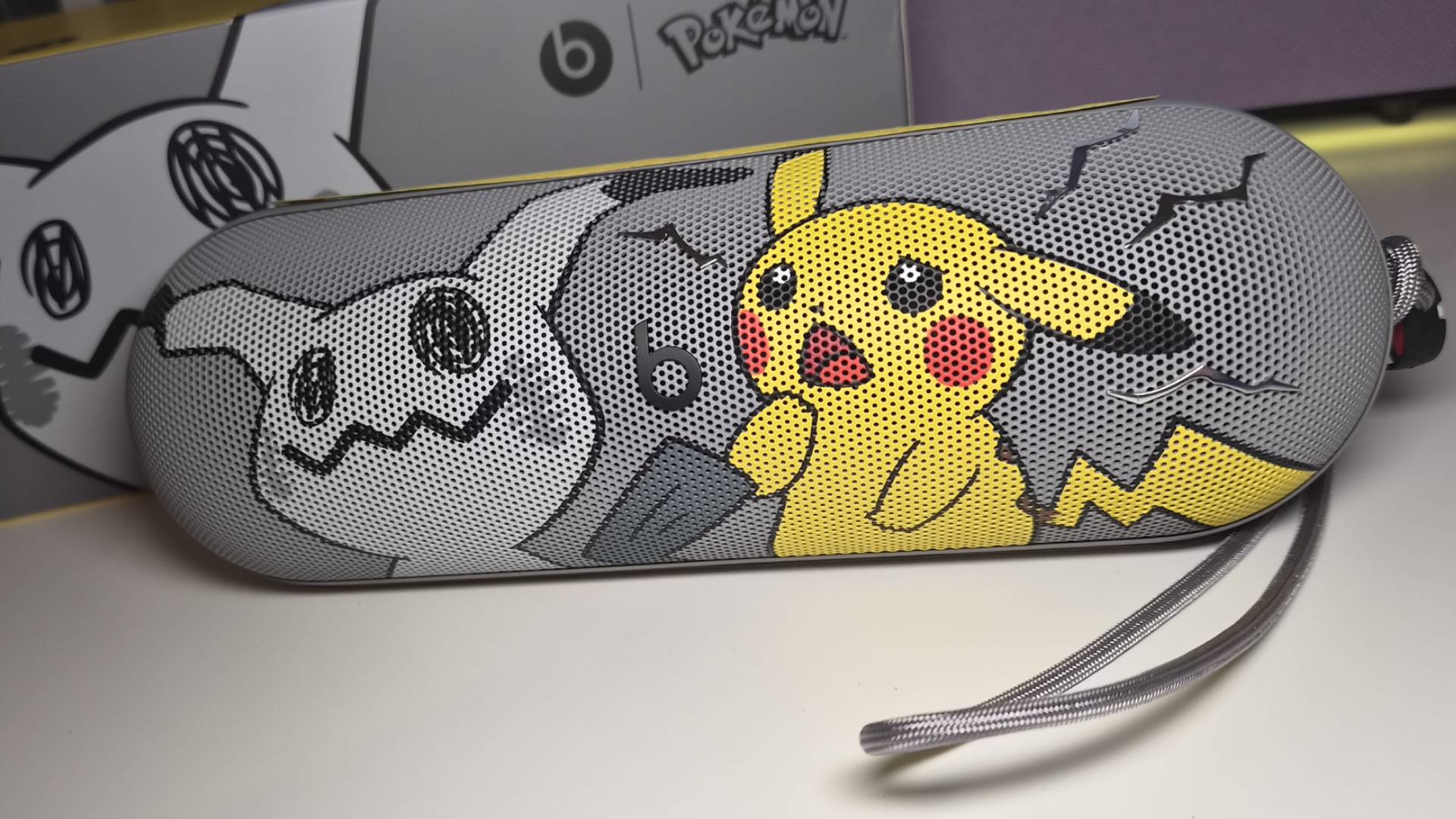 Photo of the Pokemon Beats Pill on a white gaming desk.