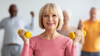 a senior woman holding dumbbells