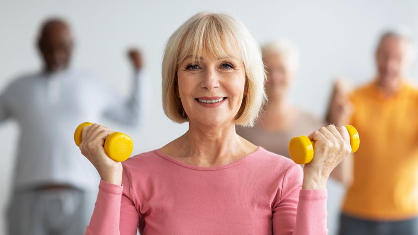 a senior woman holding dumbbells