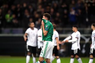 Tom Flanagan reacts after Julian Brandt makes it 6-1 to Germany