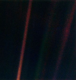 This narrow-angle color image of the Earth s a part of the first ever "portrait" of the solar system taken by Voyager 1. The spacecraft acquired a total of 60 frames for a mosaic of the solar system from a distance of more than 4 billion miles from Earth and about 32 degrees above the ecliptic. Image released Feb. 14, 1990.