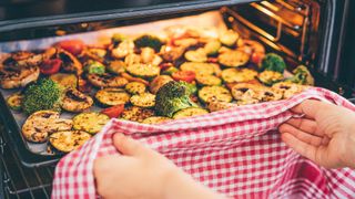 Vegetables cooking under a broiler