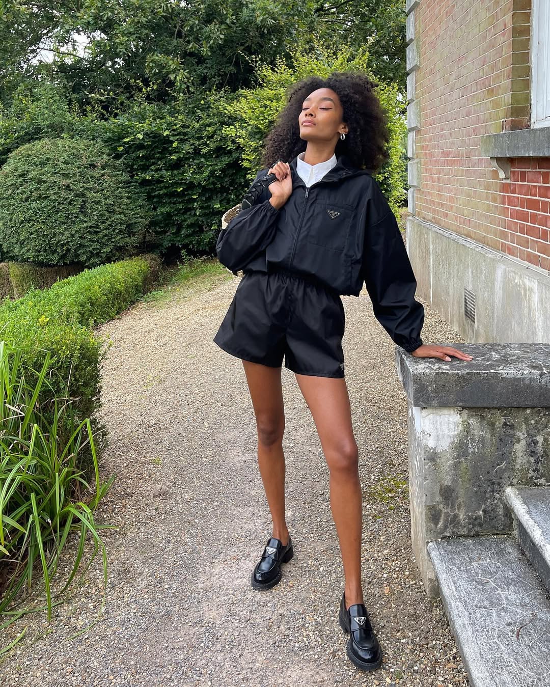 woman wearing all-black prada outfit