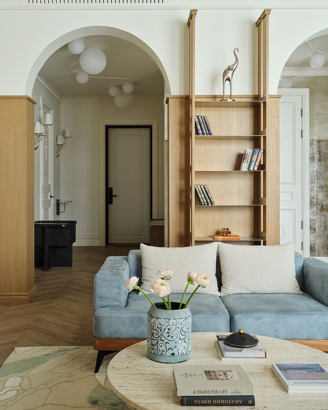 A photo of an internal arch behind a blue couch