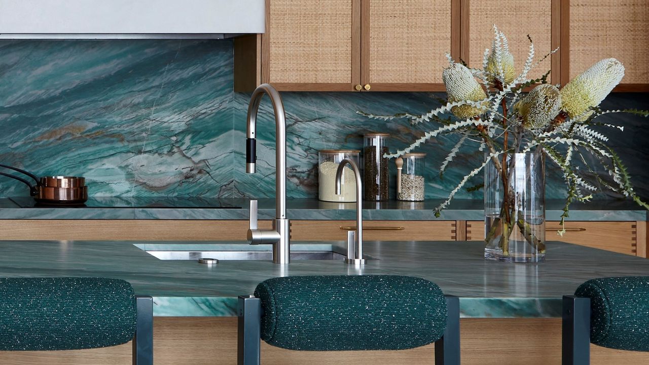 teal kitchen with timber and rattan cabinetry and a teal stone backsplash