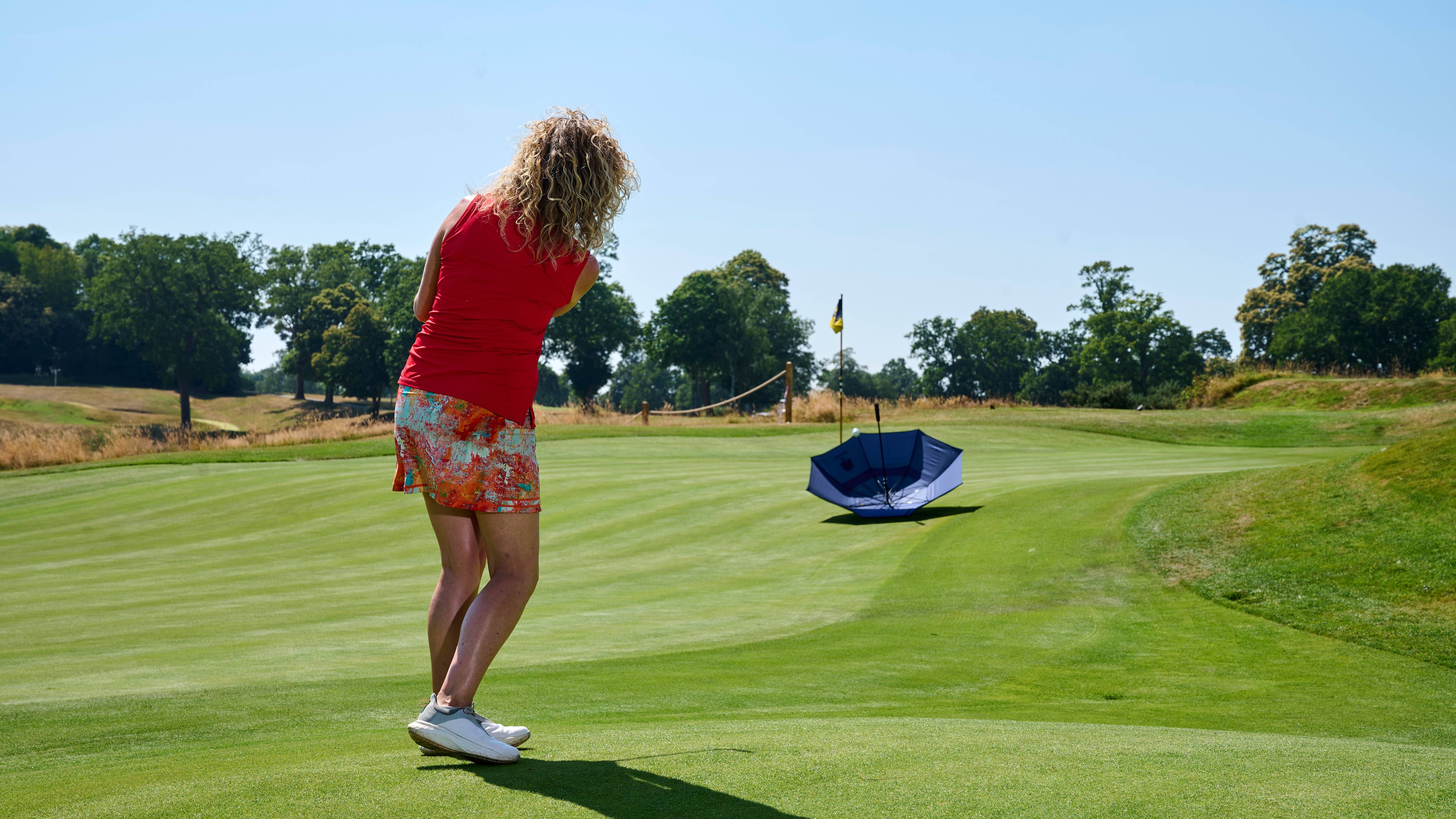 Katie Dawkins chipping into an umbrella