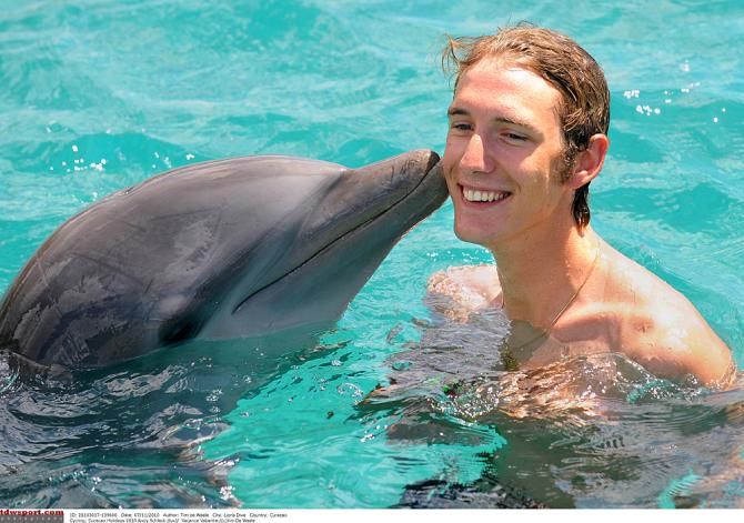 Andy Schleck swimming with dolphins in the off-season