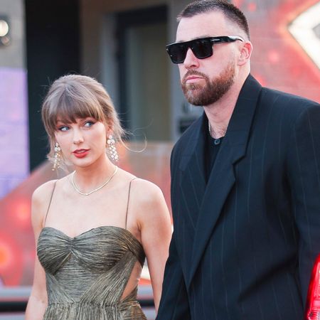 Taylor Swift wears a gold gown and sparkling shoes with Elizabeth Taylor's opal jewelry set