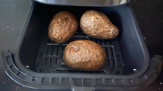 Air fryer baked potatoes in an air fryer