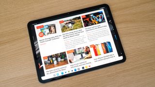 OnePlus Pad Go showing the Digital Camera World homepage on a wooden table