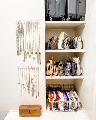 A shelf with organized purses and a wall of hanging jewelry