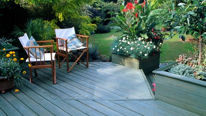 A blue painted decking area in a backyard 