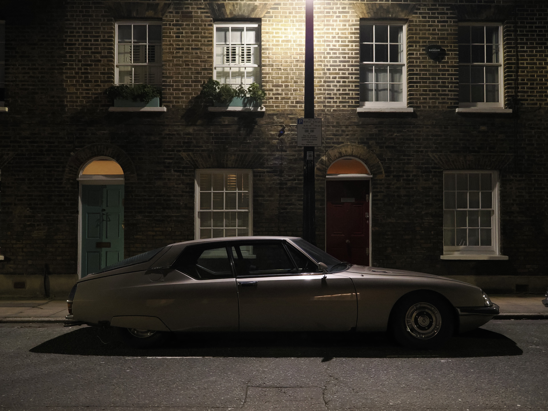 OM System OM-3 sample photos: classic car in quaint London street at night