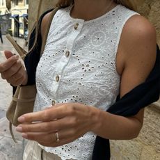 Woman in white embroidered top