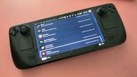 Hnadheld gaming console on pink background
