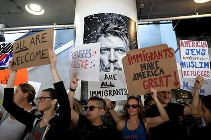 President Trump blamed protesters, like these at LAX, for the chaos caused by his executive order.