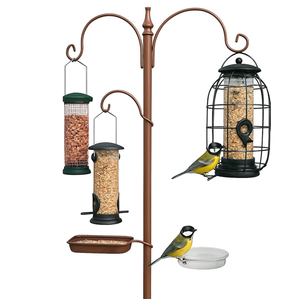 hanging bird feeders on a brass pole