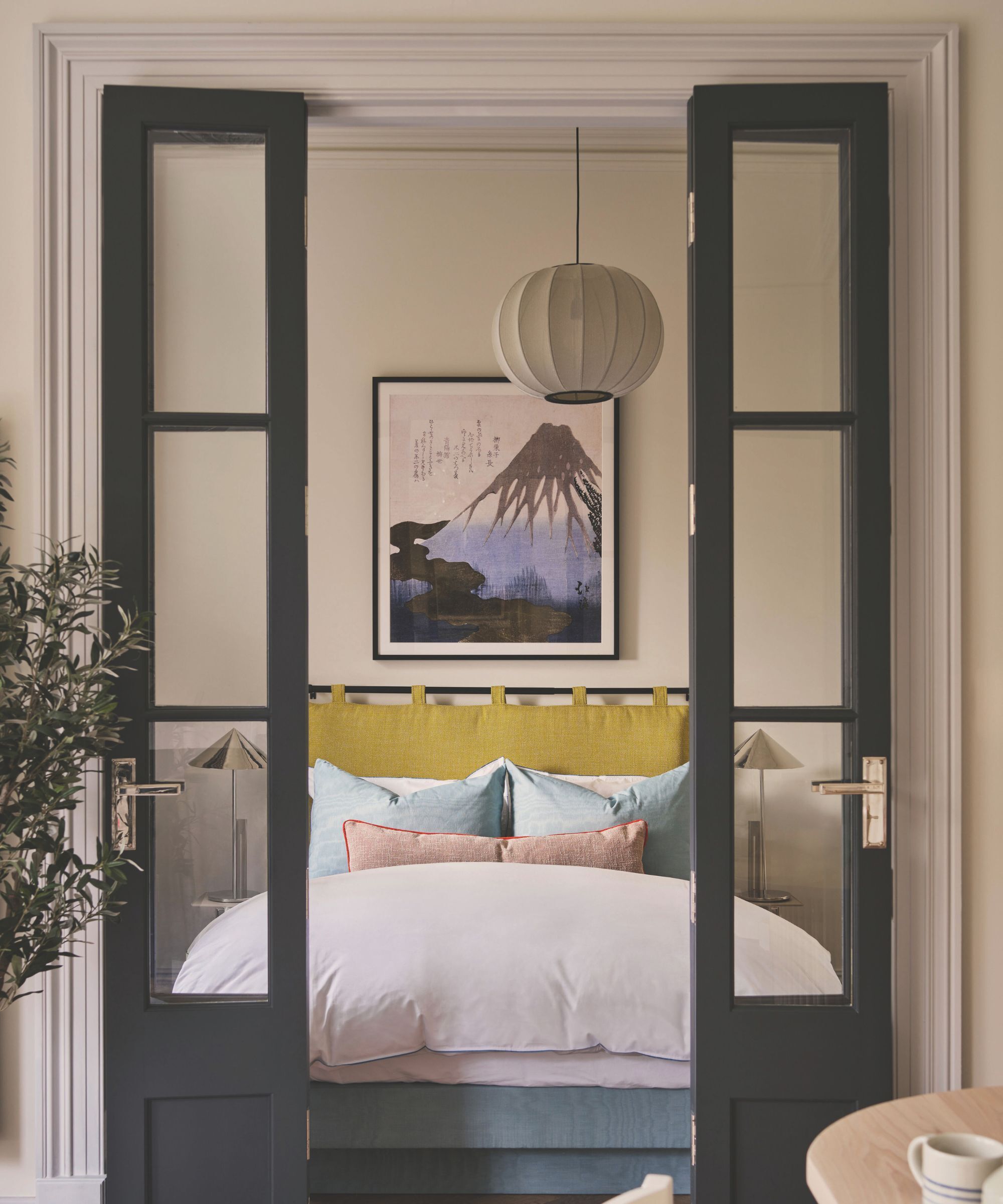 Sliding doors to a double bedroom with pastel coloured linen bedding