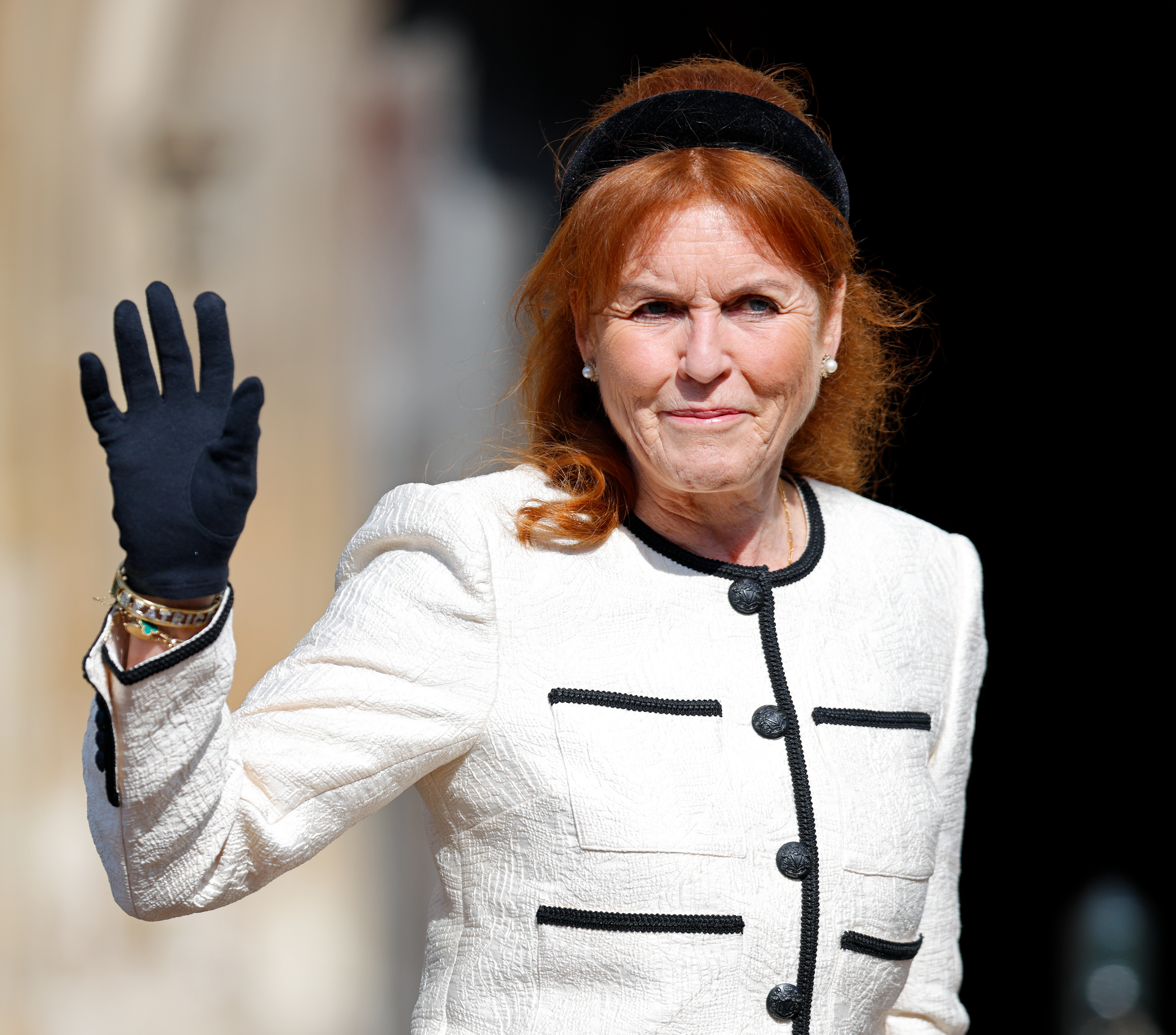 Sarah Ferguson waving in a white suit jacket
