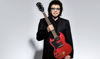 Tony Iommi holds his new Epiphone signature SG Special guitar