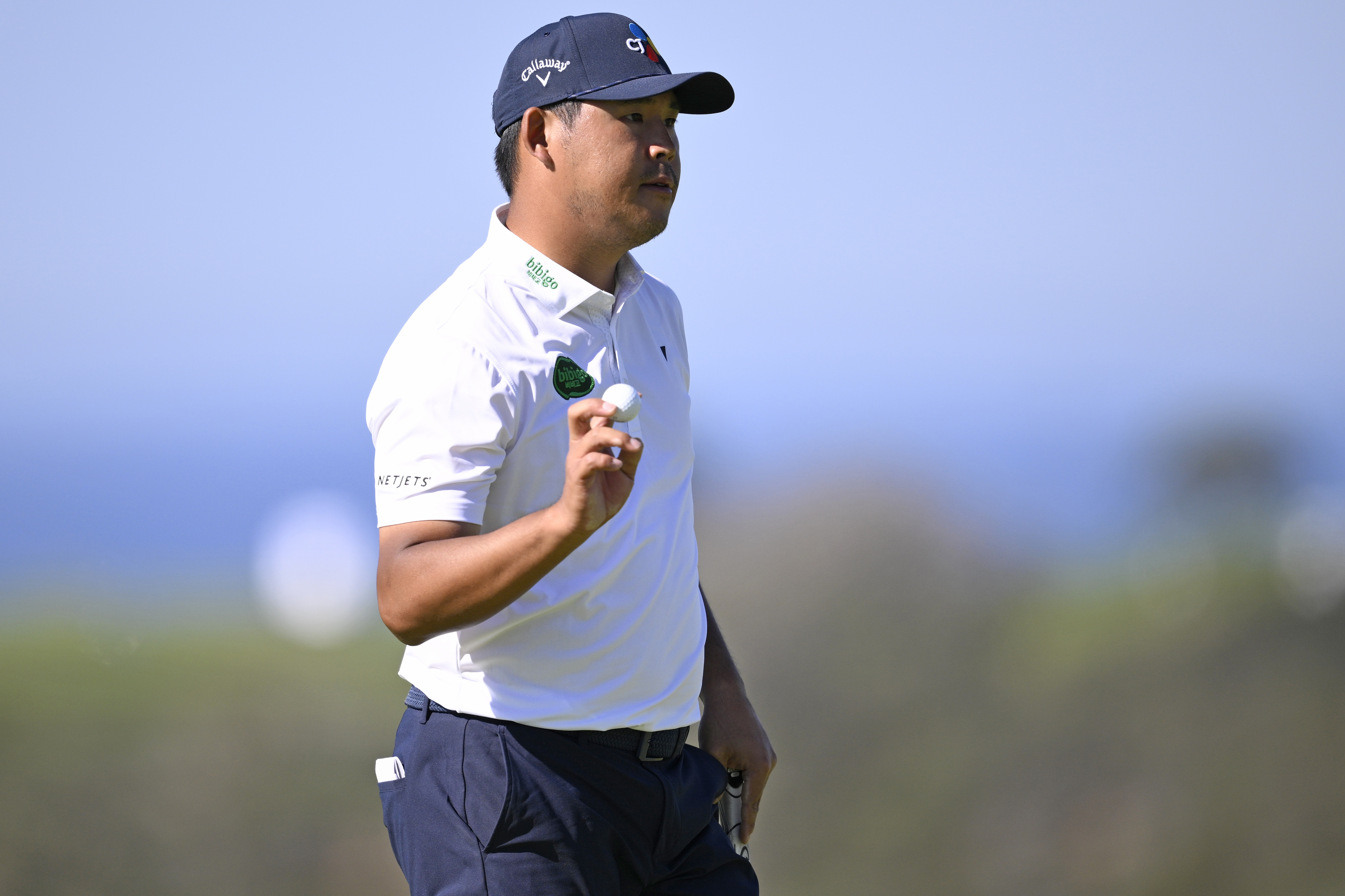 Si Woo Kim reacts to his putt on the 13th green during the final round of the Farmers Insurance Open