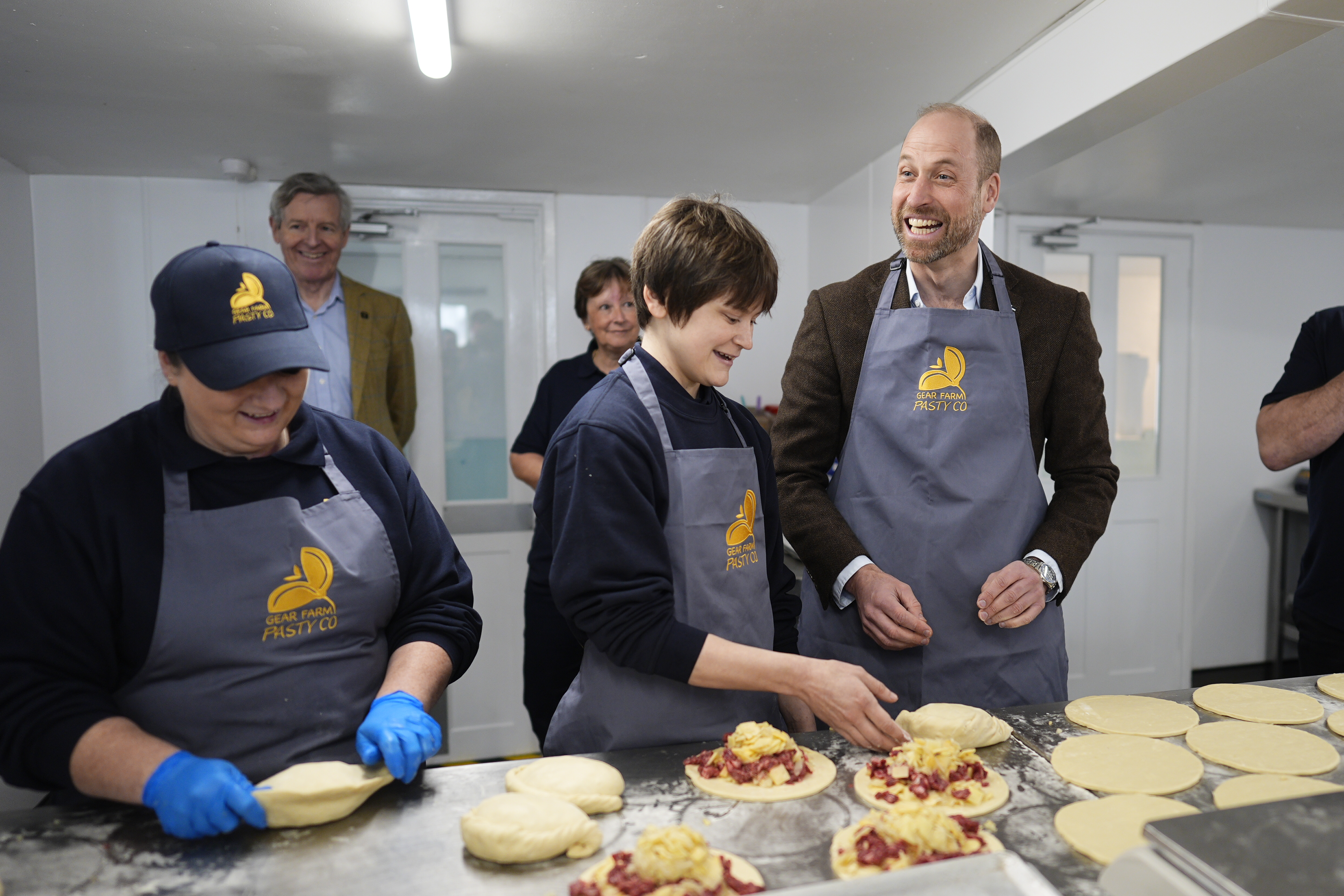 Prince William making pasties wearing an apron