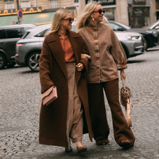 guests attend Paris fashion week spring summer 2025 in brown coats and jackets 